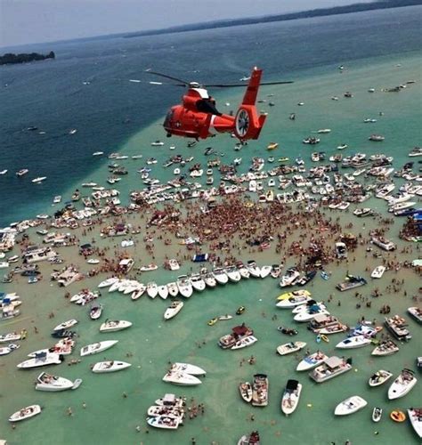 Torch lake sand bar - The sandbar at the south end of Torch Lake is a site where numerous people congregate to boat, wade, swim and, in general, enjoy the lake during week-ends and holidays. The Fourth of July holiday, in particular, has recently been seeing a dramatic increase in human occupancy at the sandbar. In the